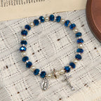 Pulsera elástica de cristal transparente moderno con crucifijo y medalla milagrosa: una declaración de fe contemporánea