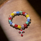 Pulseras de cristal coloridas que brillan en la oscuridad con motas doradas y crucifijo