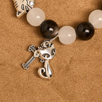 Bracelet chapelet animal Notre-Dame en perles avec chat-vache noir et blanc