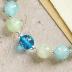 Bracelet de perles pailletées changeant de couleur aux UV avec croix ornée : Scintillez dans des tons de foi