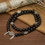 Pulsera de cuentas de sándalo con Medalla Milagrosa y alas de ángel