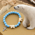 Bracelet en croix fait à la main « Ours polaire Perle bleue » : Sauvons nos ours polaires