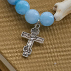 Bracelet en croix fait à la main « Ours polaire Perle bleue » : Sauvons nos ours polaires
