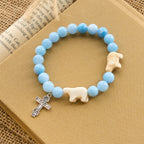 Bracelet en croix fait à la main « Ours polaire Perle bleue » : Sauvons nos ours polaires